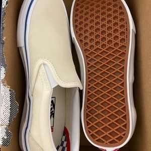 Slip on cream-colored vans. Brand new